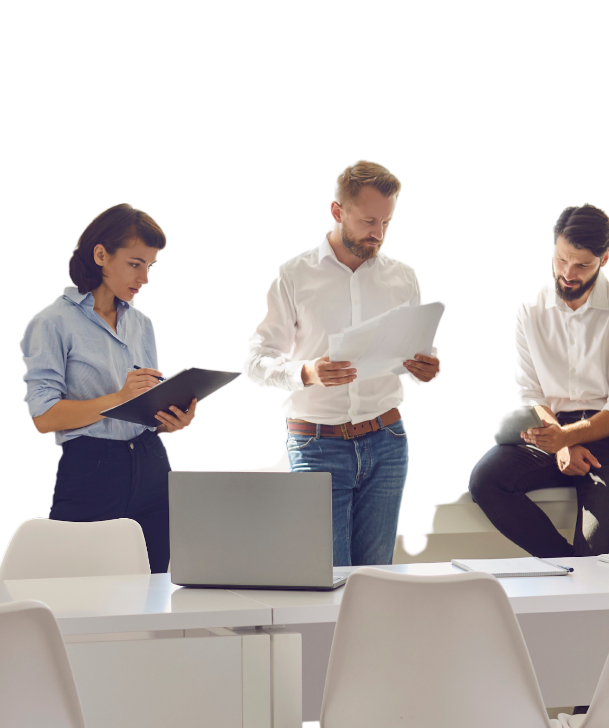 Office team reviewing printed reports and a laptop in a meeting — Umbrella IT Group small business compliance support